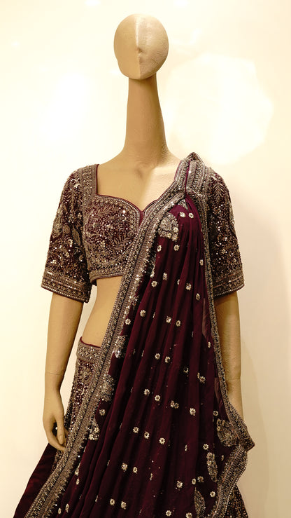 Burgundy bridal lehenga with intricate embroidery