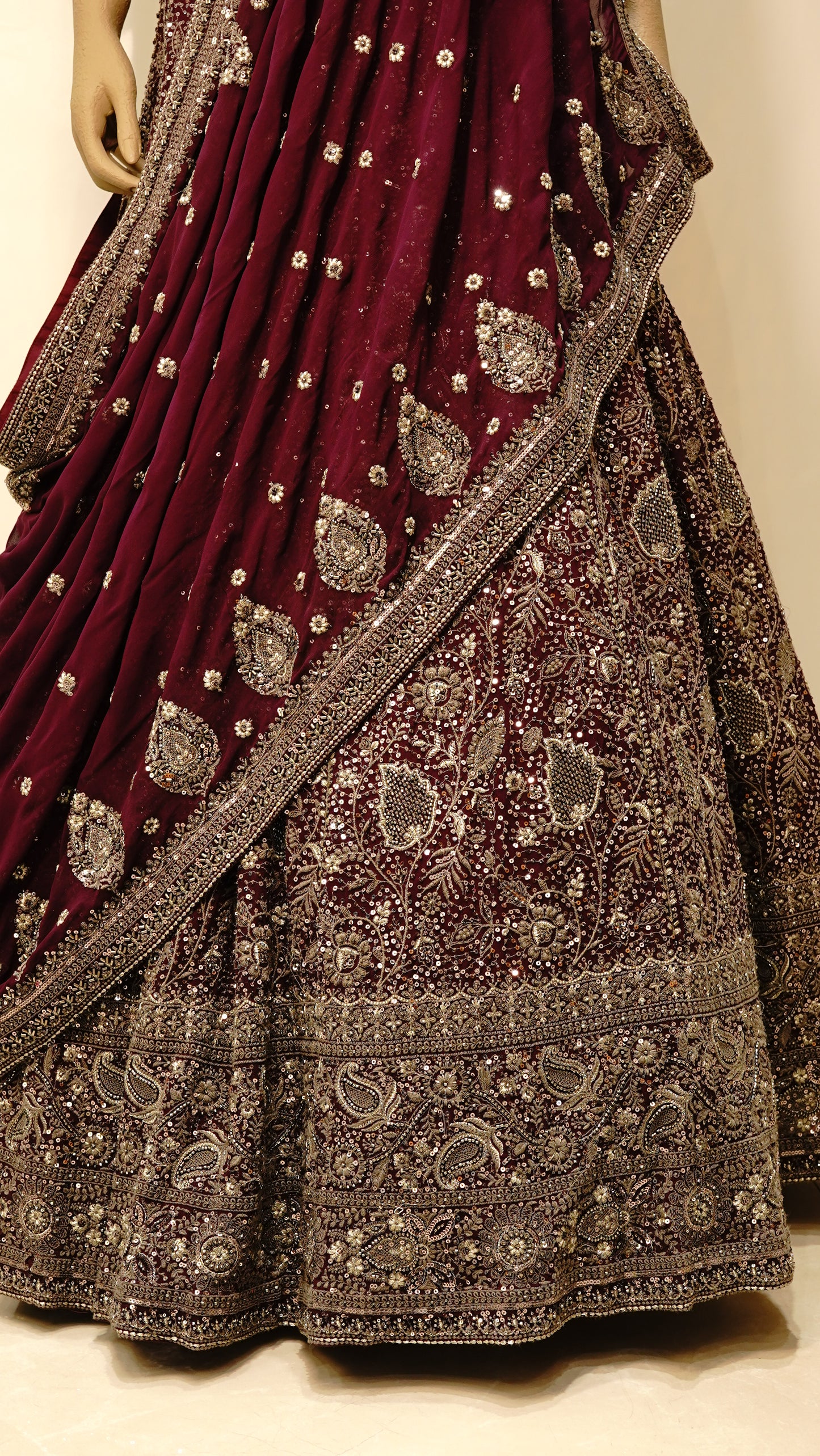 Burgundy bridal lehenga with intricate embroidery