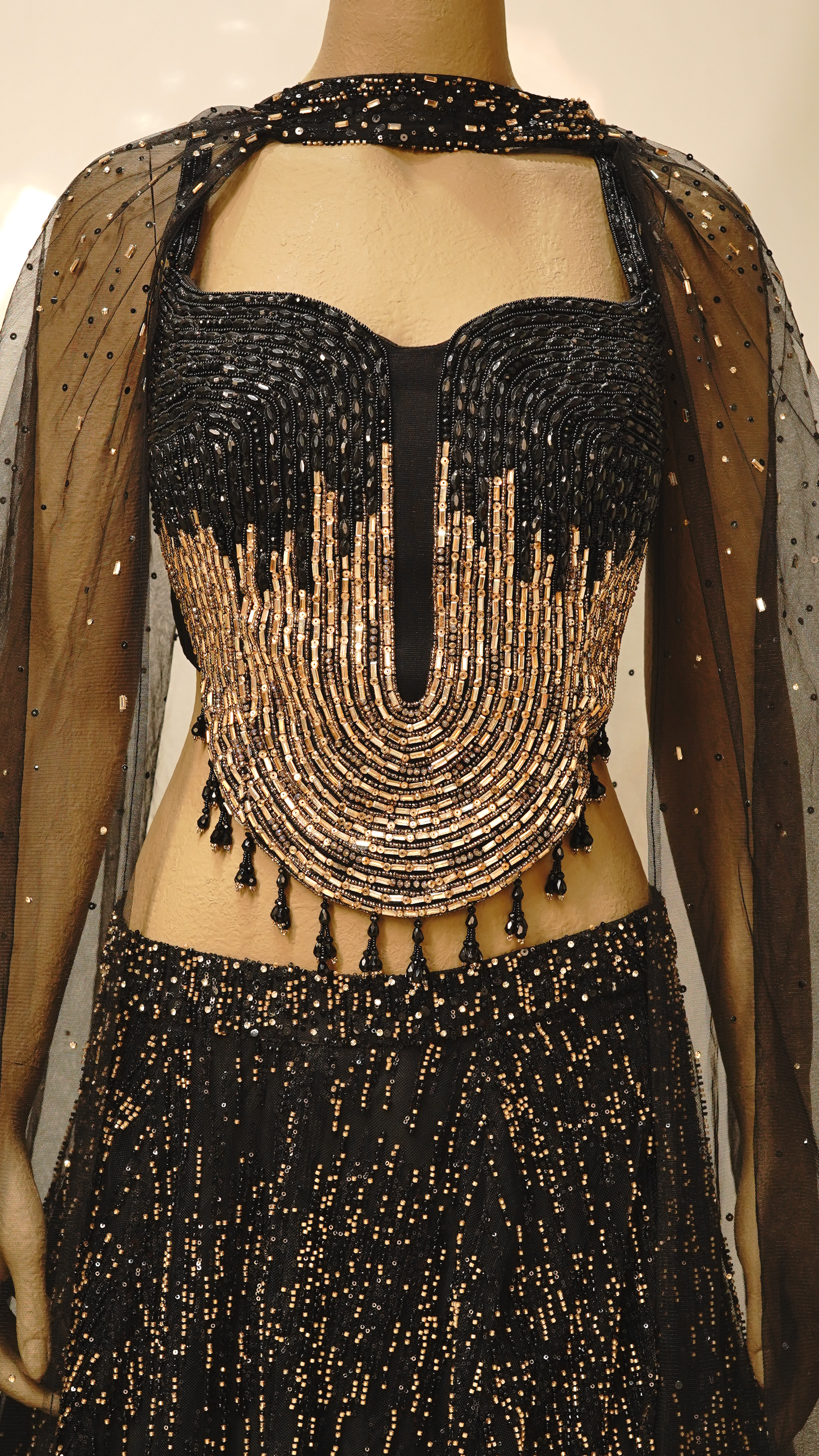 A striking black lehenga with Metallic Gold embellishments