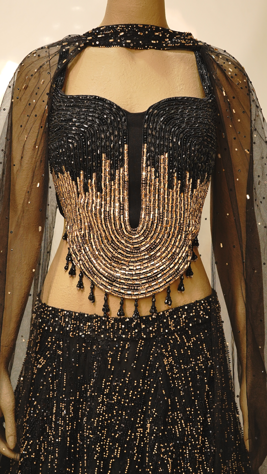 A striking black lehenga with Metallic Gold embellishments